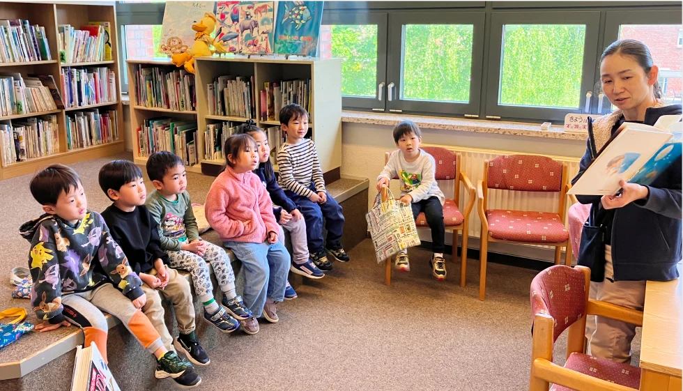 先生の読む絵本を楽しむ子供たち